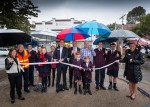 Pictured: The ‘brollied’ local residents together with St Michael’s Grammar Principal Simon Gipson, staff and students plus Cr Andrew Bond watch-on as MP Clem Newton Brown cuts the ribbon.